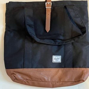 Hershel supply company black tote bag with leather bottom.